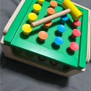 Green and Yellow Learning Toy with Colorful Pegs